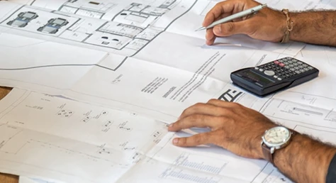 Construction professional reviewing architectural drawings